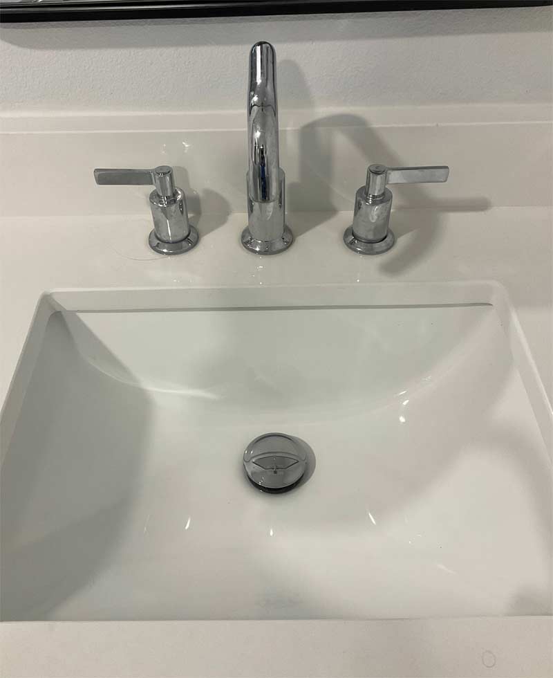 bathroom faucet with white porcelain sink