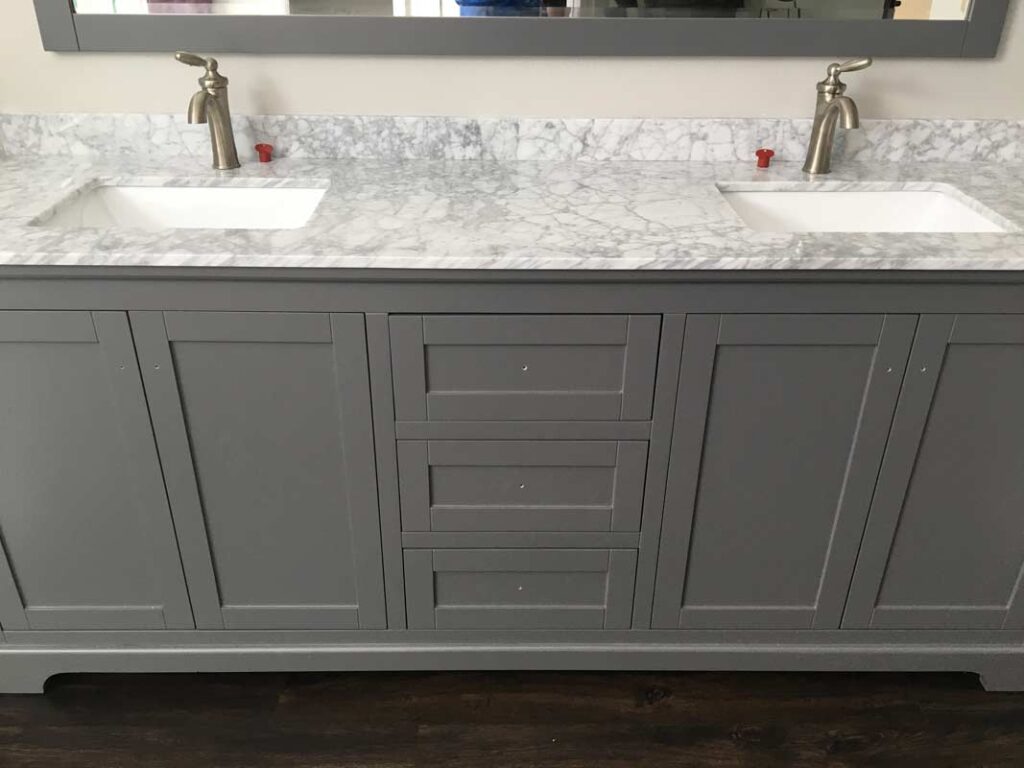 Dual sink vanity with single handle faucets